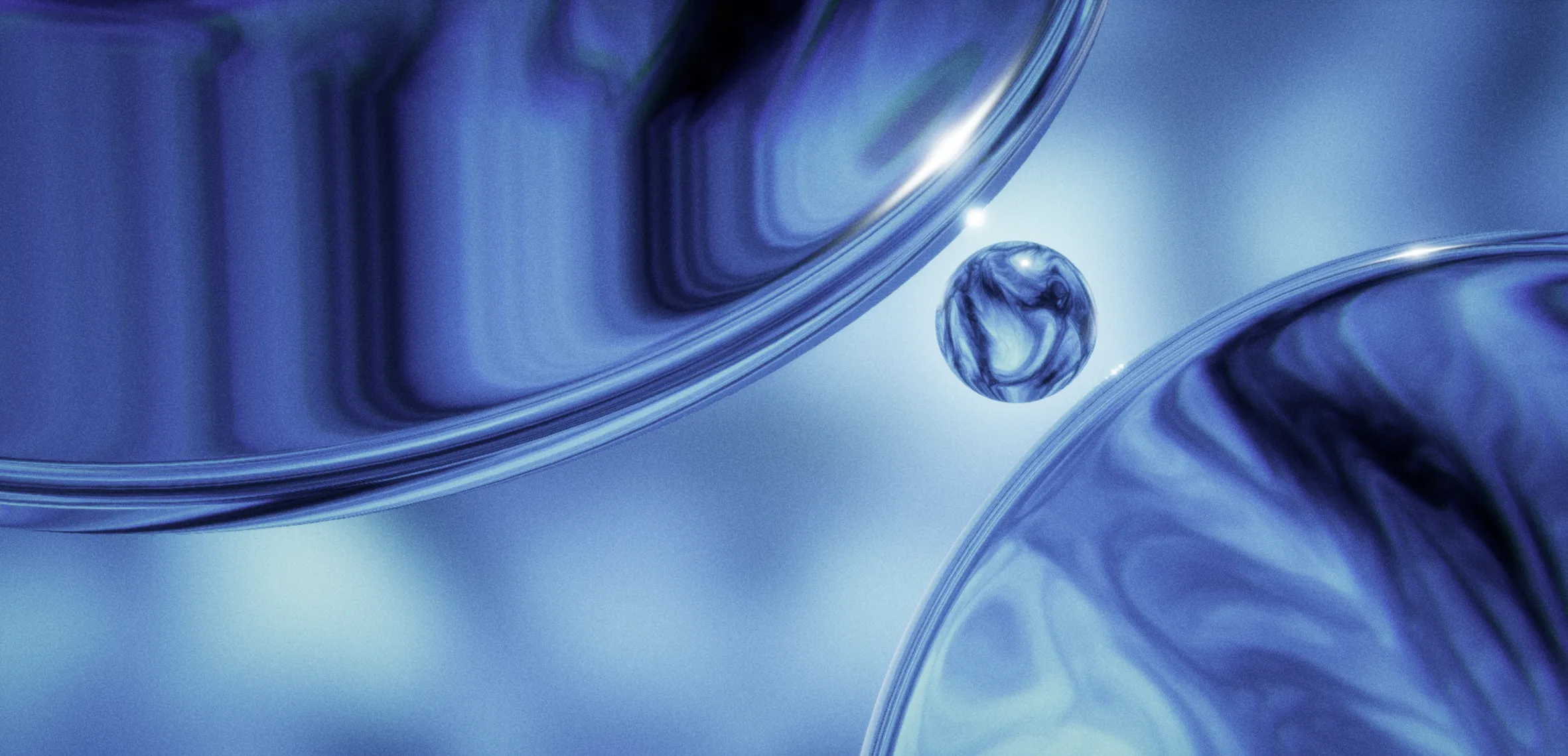 Small glass orb suspended between reflective blue fluid forms